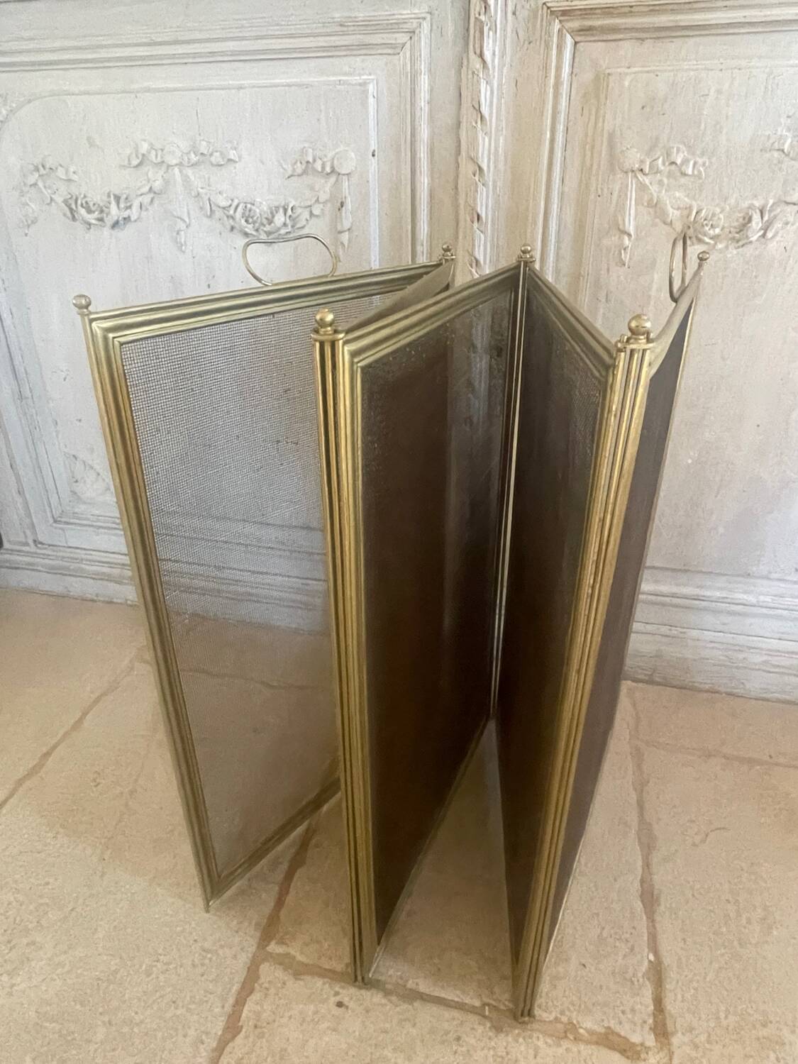 Five-panel golden metal fireplace screen from the 19th century.