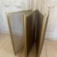 Five-panel golden metal fireplace screen from the 19th century.