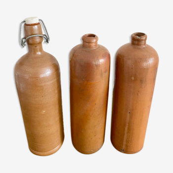 Trio of old sandstone bottles
