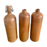 Trio of old sandstone bottles