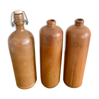 Trio of old sandstone bottles