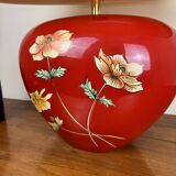 large vintage ceramic lamp with flower decorations on a red background circa 1980