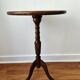 Small tripod wooden table with a vintage round top -