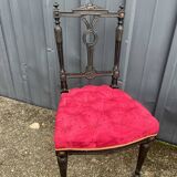 Pair of black lacquered chairs with purple tufted upholstery.