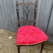 Pair of black lacquered chairs with purple tufted upholstery.