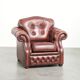 Cowhide chesterfield armchair in a warm brown colour with decorative nails