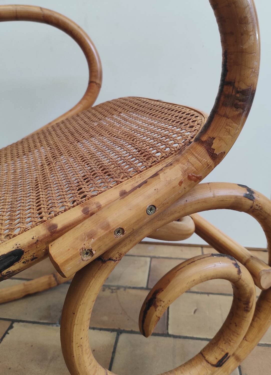 Vintage rocking chair in rattan and cane.