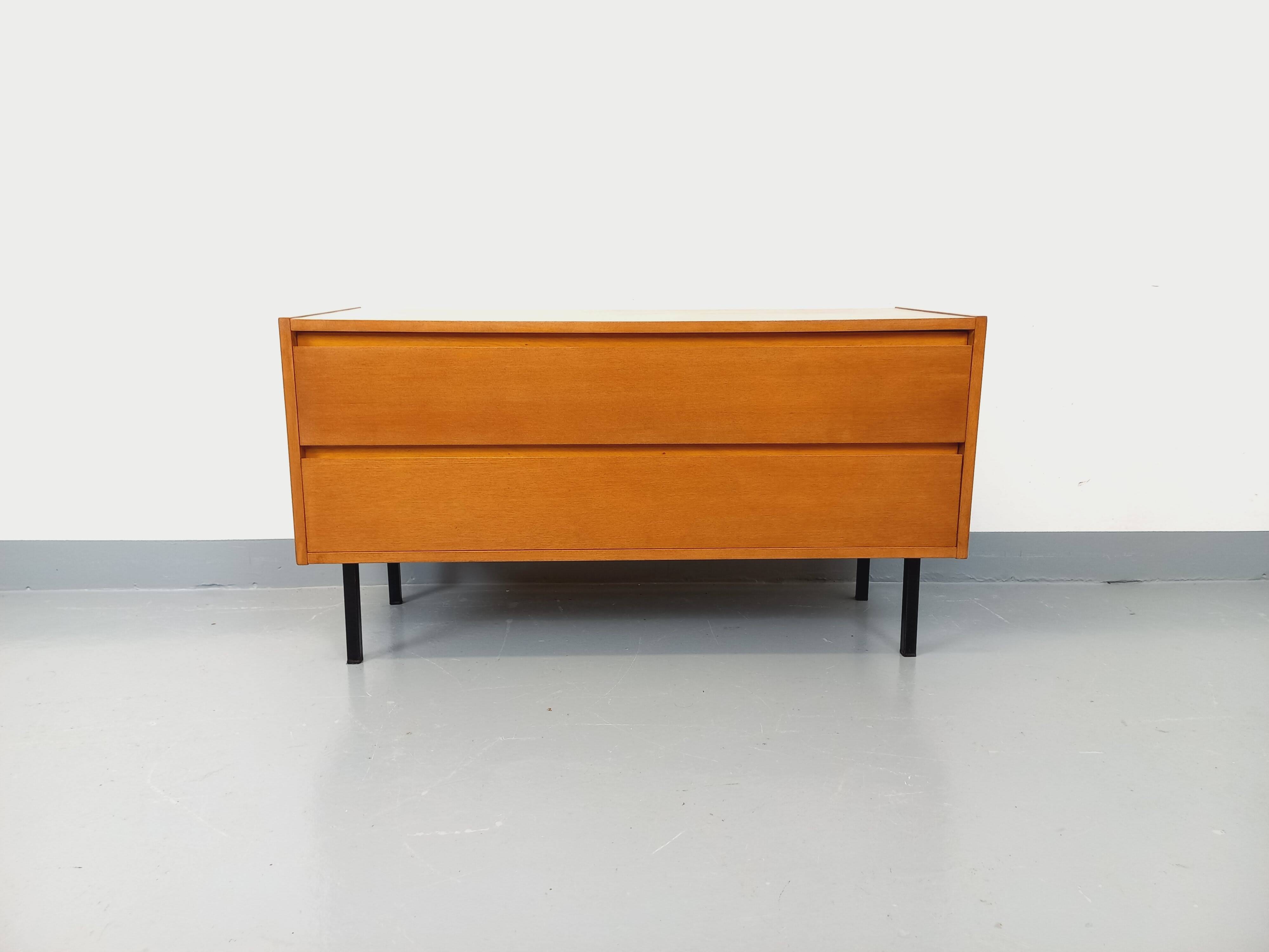 Small vintage Scandinavian sideboard in modernist style made of light oak wood.