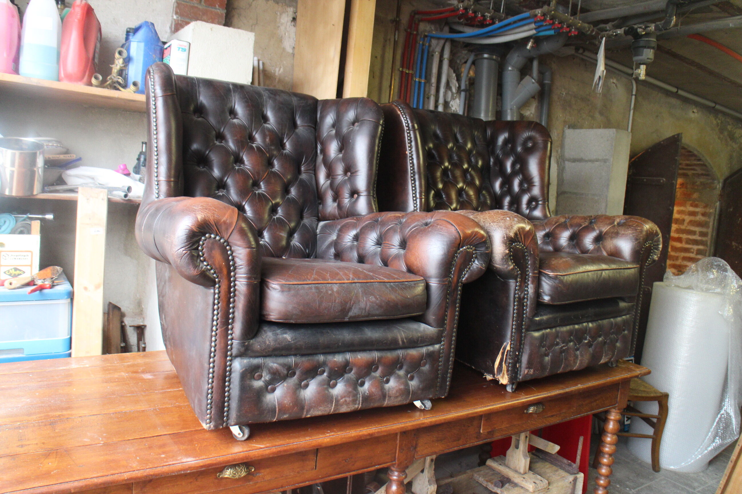 Padded chesterfield leather armchairs