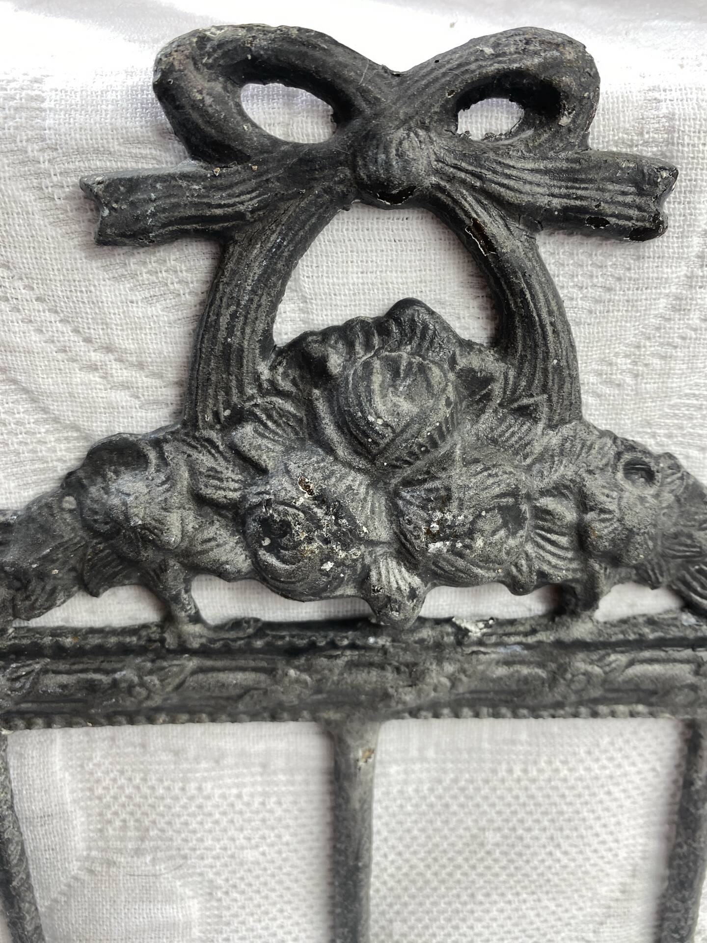 Patinated metal wall bracket and porcelain