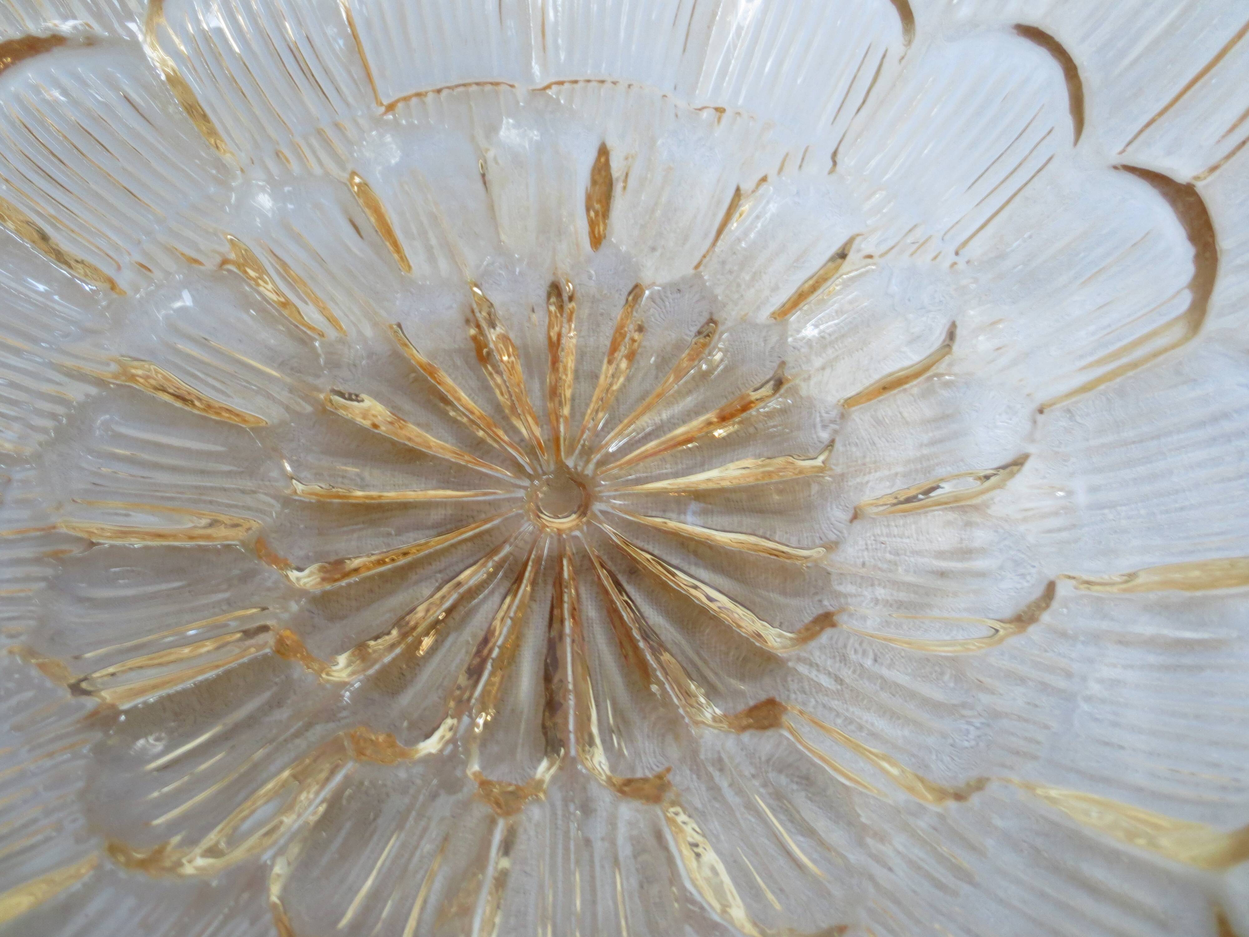 ceiling light with amber glass globe, on a round light wood base