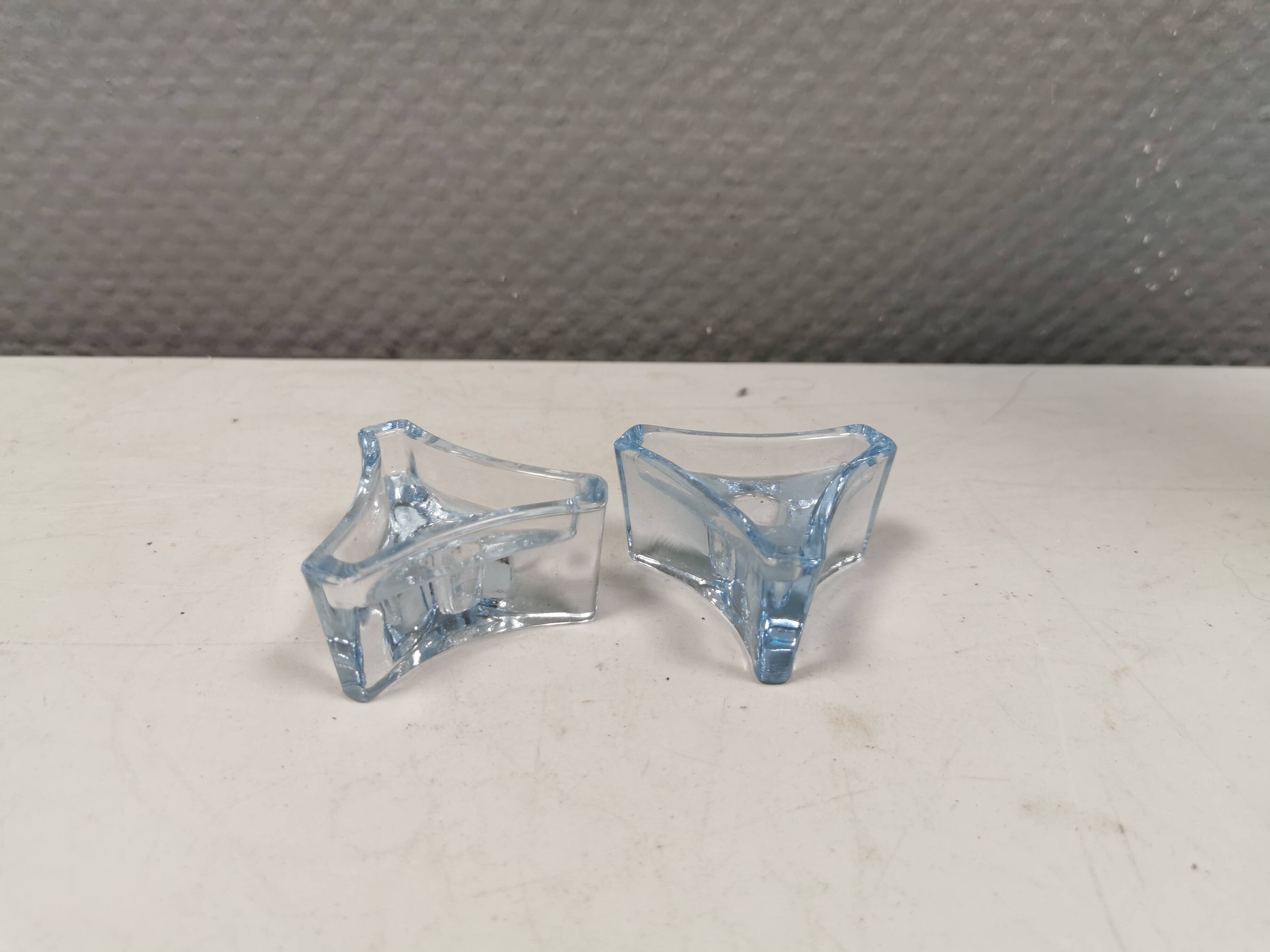 Two beautiful glass candle holders in translucent bluish glass.
