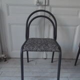 Indus chair with tubular structure in slate gray metal waxed finish, upholstered seat.