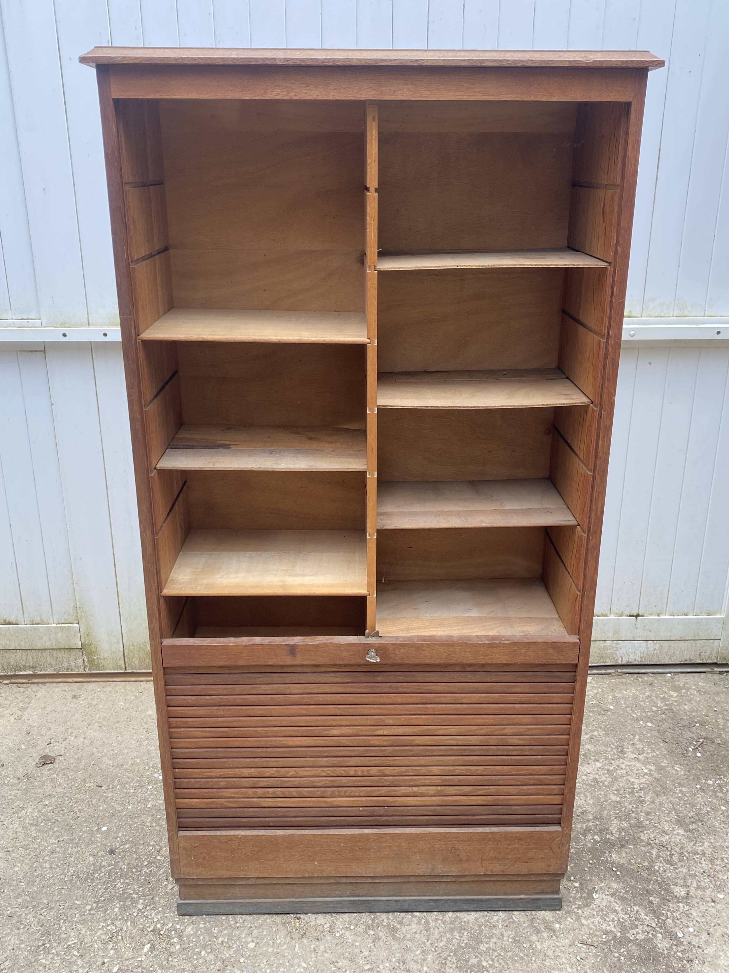 Oak two-column filing cabinet with curtains.