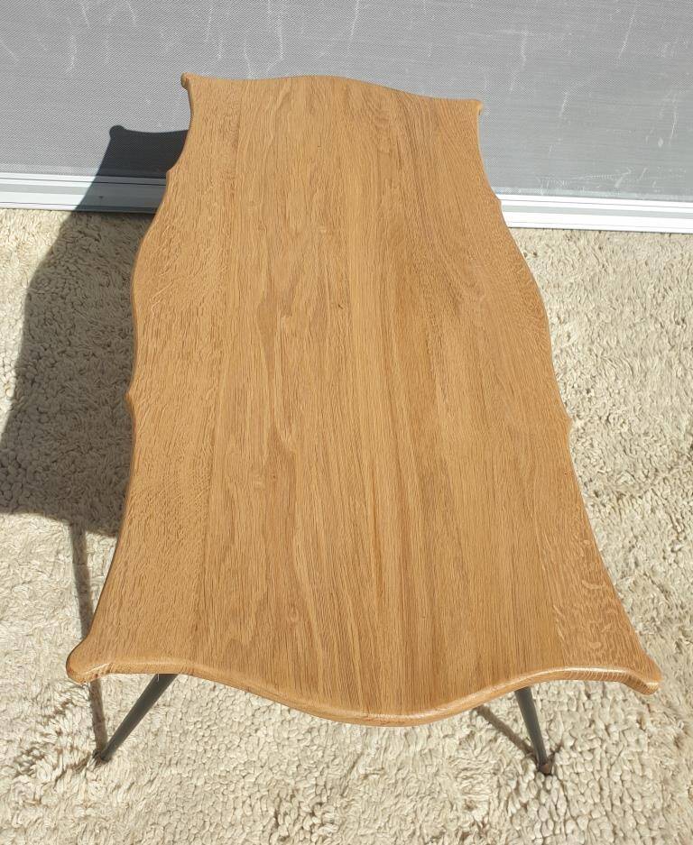 Violin-shaped coffee table with brass legs