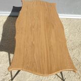 Violin-shaped coffee table with brass legs