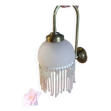 Brass swan neck wall lamp with pink glass globe and Charleston tassels