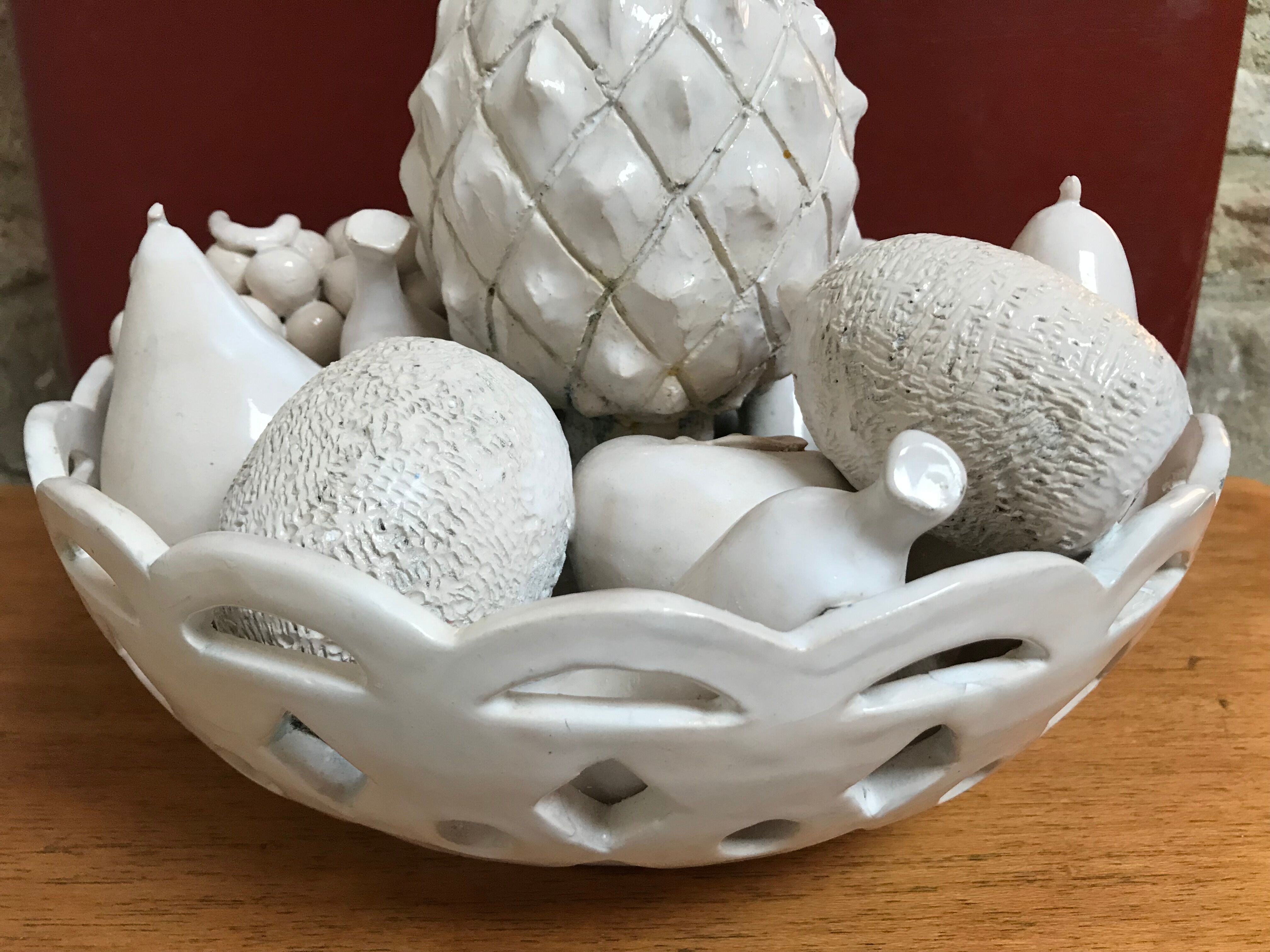 Trompe l'oeil fruit cut in white earthenware by Jean Roger, circa 1960.