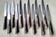 Box of 12 table knives with horn handles, silver-plated metal and stainless steel.
