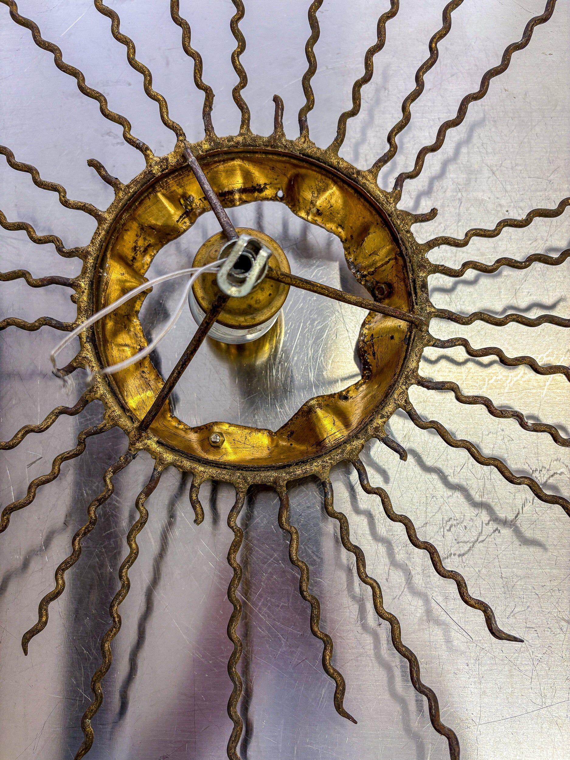 Spanish sunburst ceiling light – gilt iron rays & exposed bulb, 1960s