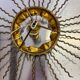 Spanish sunburst ceiling light – gilt iron rays & exposed bulb, 1960s