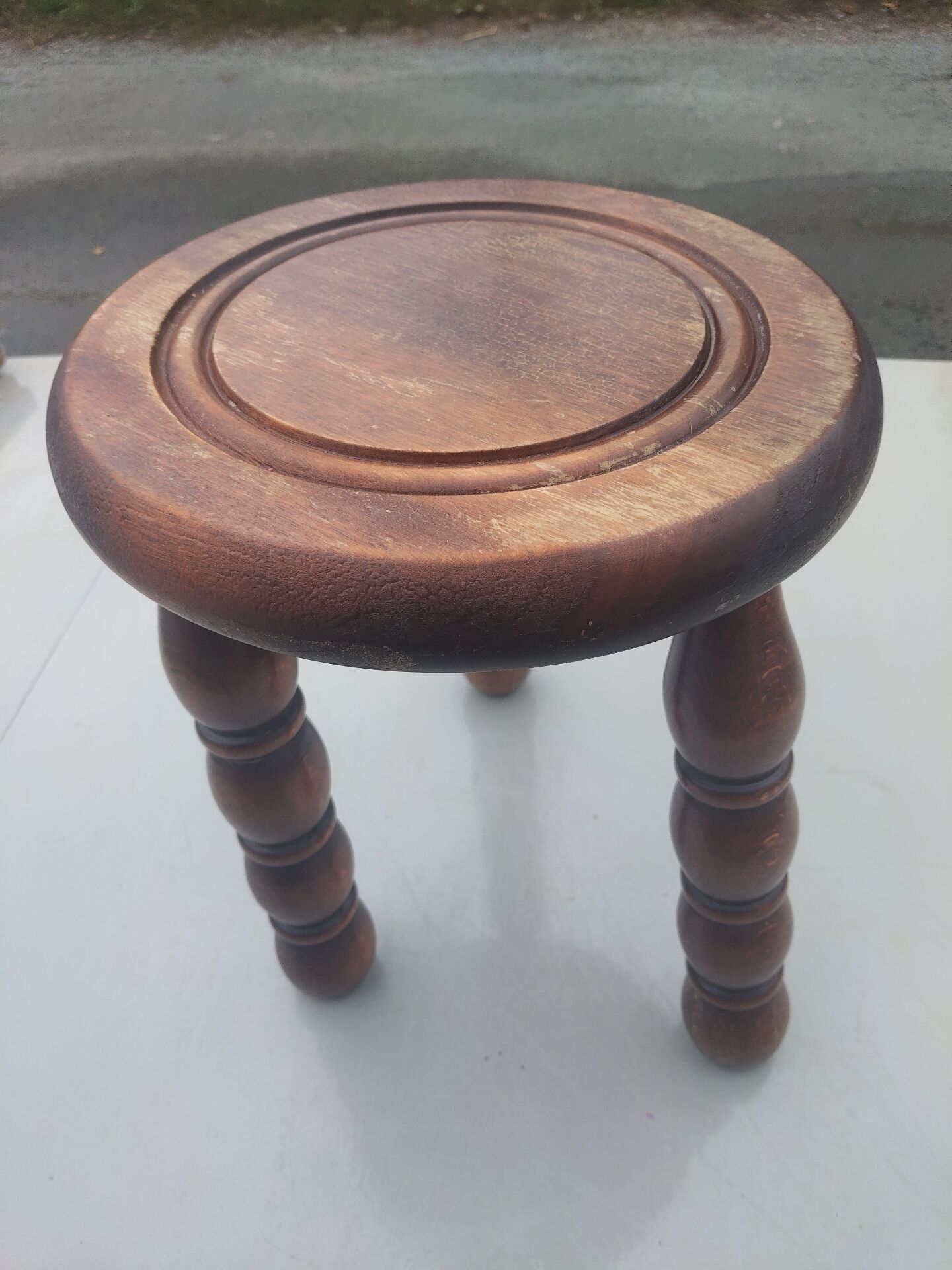 Small vintage tripod stool made of turned wood, in the style of Charles.