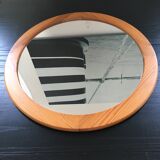 Round mirror in varnished pine