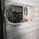 Oval mirror in white lacquer from the 1970s.