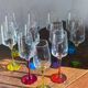 Champagne coupes in glass, multicoloured stems.