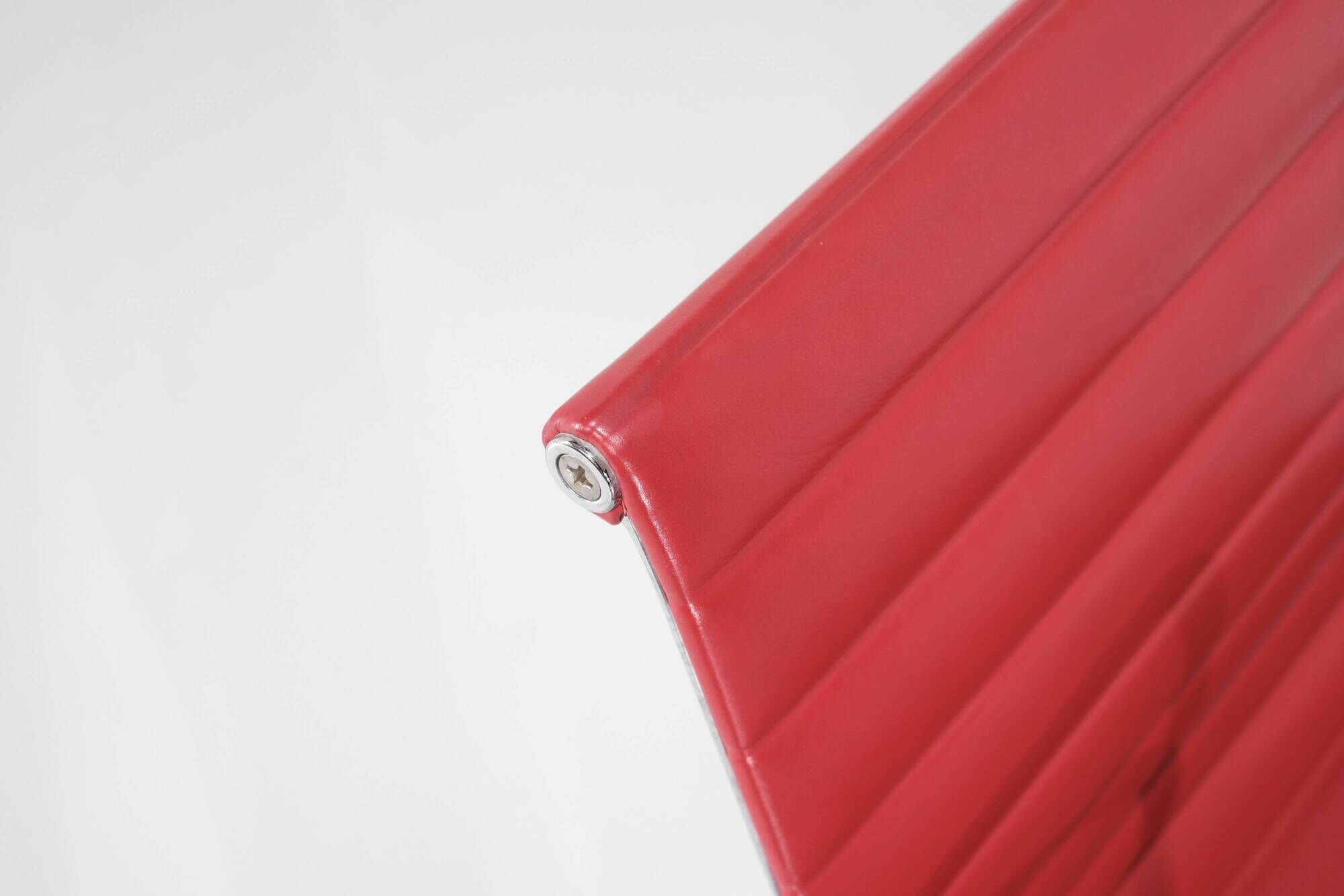 "EA 108" armchair in red leather, designed by Charles and Ray Eames for Vitra,