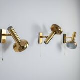 Set of three brass adjustable wall lamps