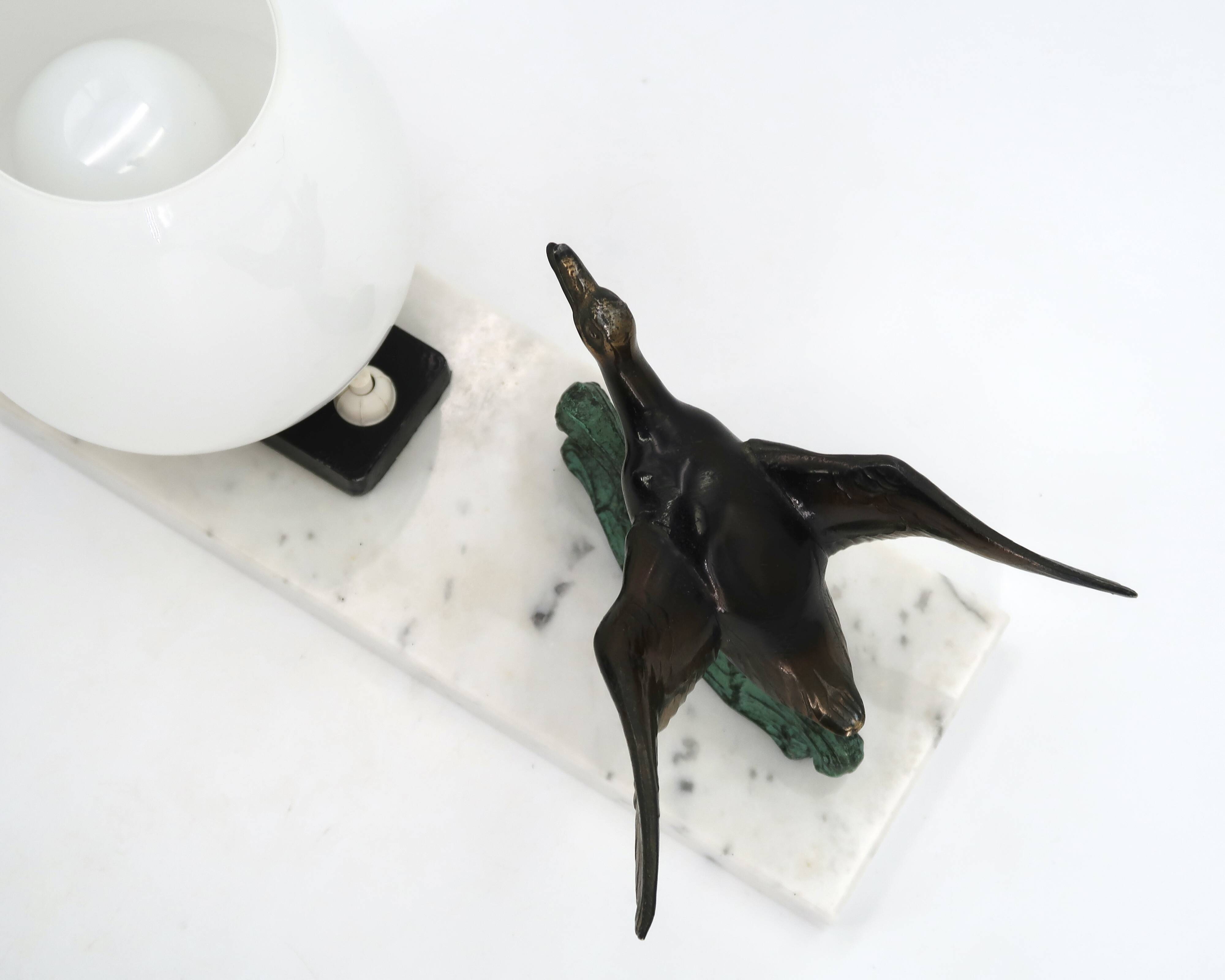 Art Deco lamp decorated with a flying duck, marble base, 1930s.