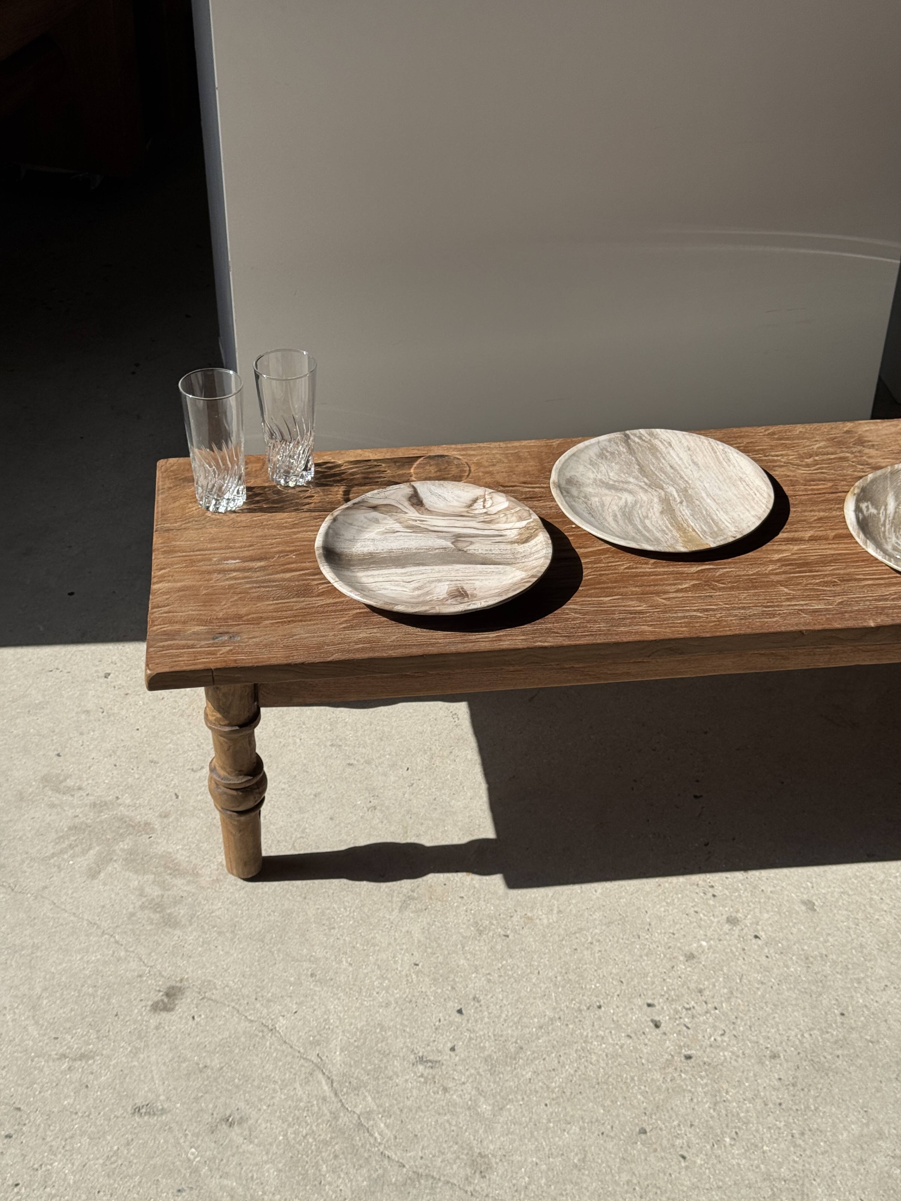 Tray, circular dish or plate made of white striped grey petrified wood.