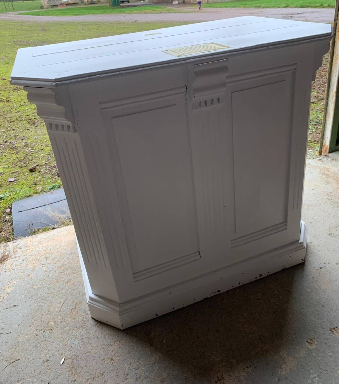 White counter with brass coin mechanism