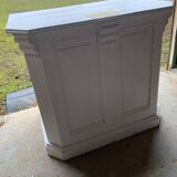 White counter with brass coin mechanism