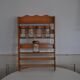 Brown wooden wall spice rack with a set of 6 glass jars, 1950s vintage style.