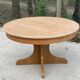 Round extendable Scandinavian dining table in Baumann style oak with central leg