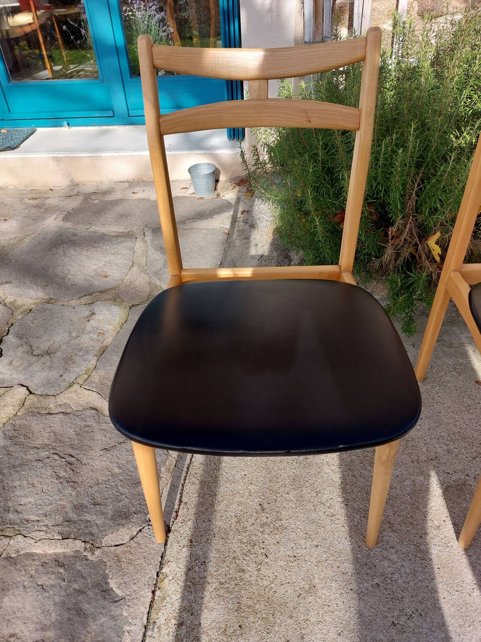 3 Scandinavian style chairs, light wood and black faux leather.