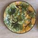 Four antique dessert plates in majolica with vine decoration.
