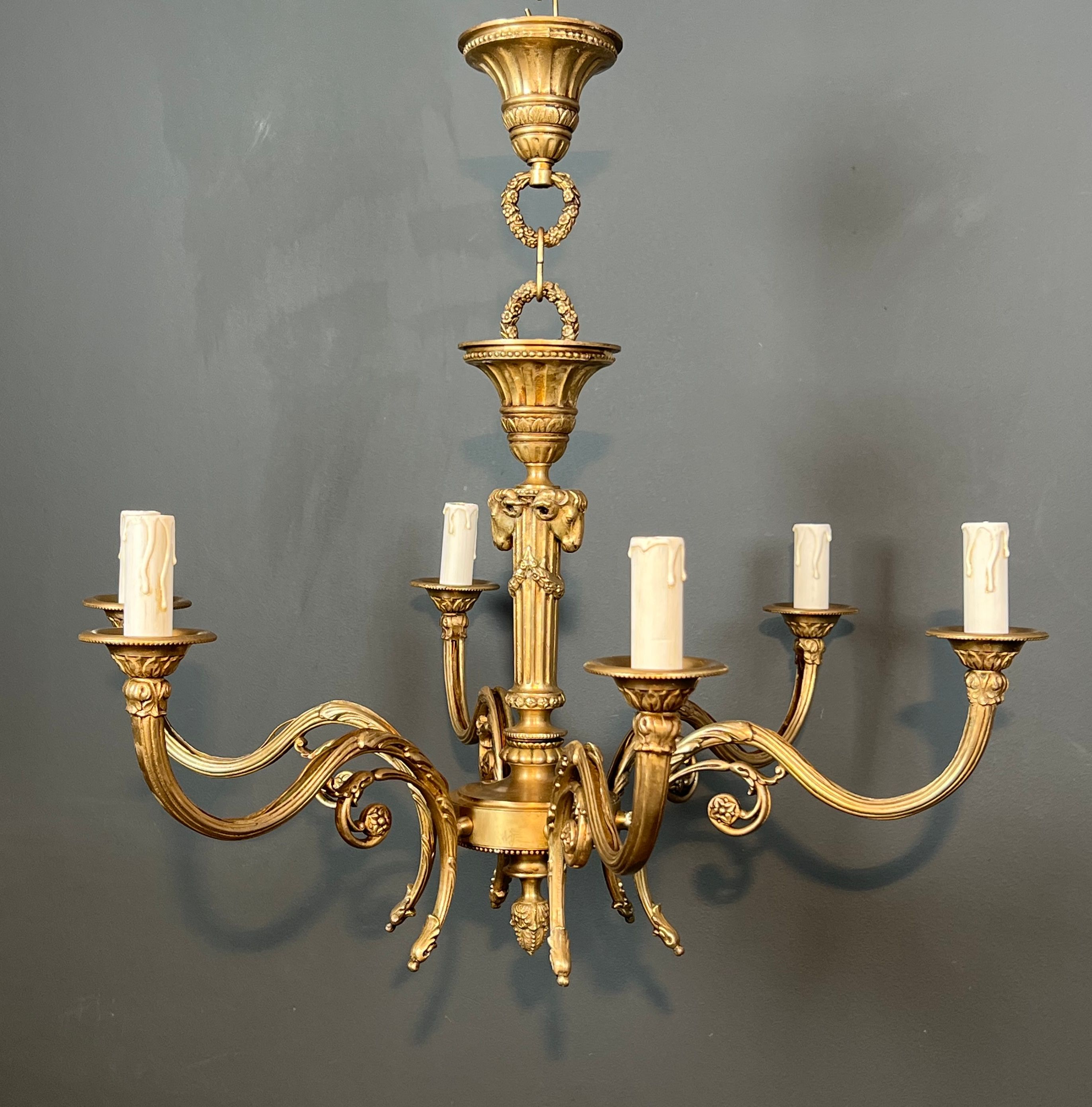 Bronze chandelier with ram's head motifs in the Louis XVI style, in the manner of Maison Jansen.