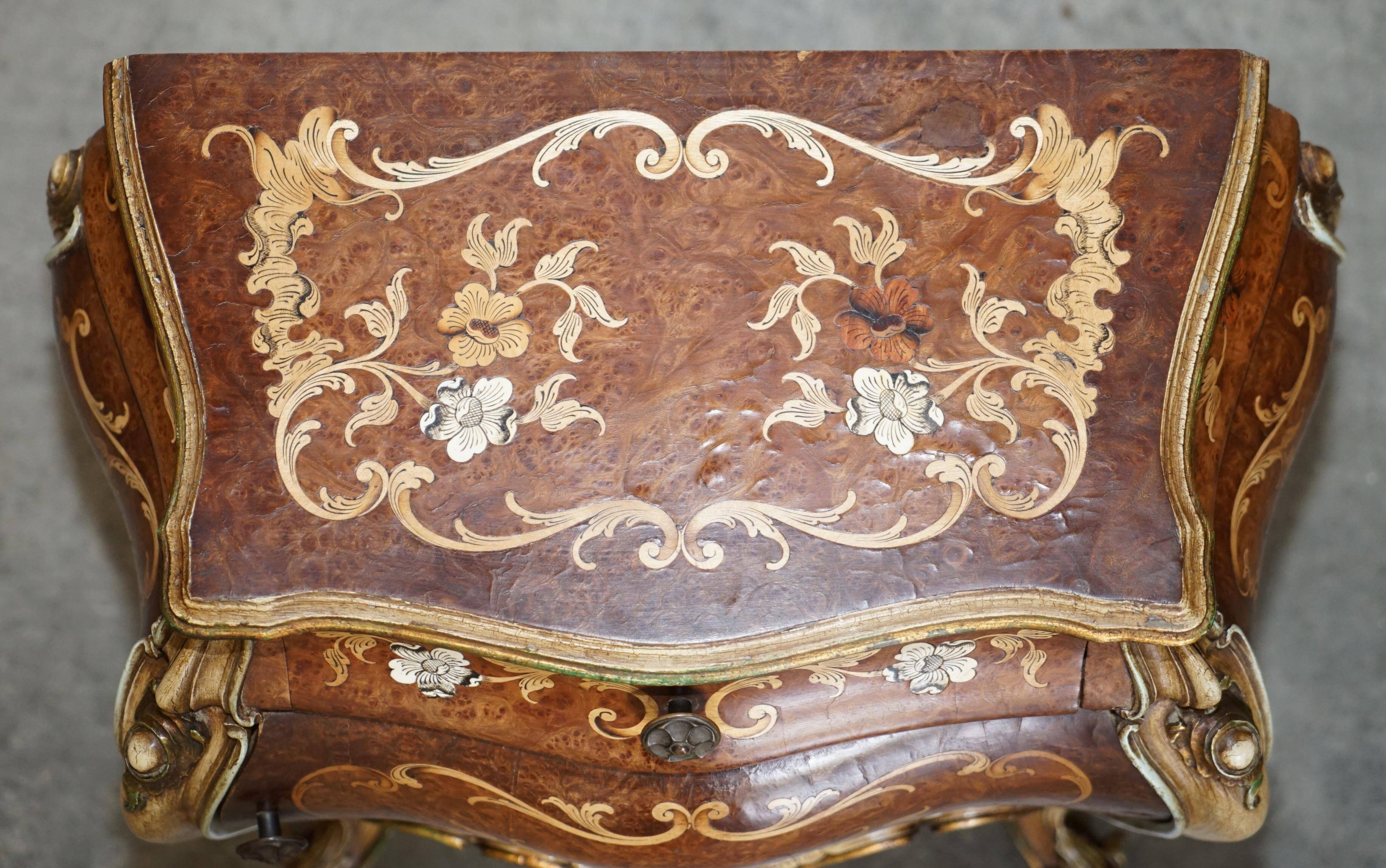 Pair of curved walnut commodes with marquetry and marble tops.