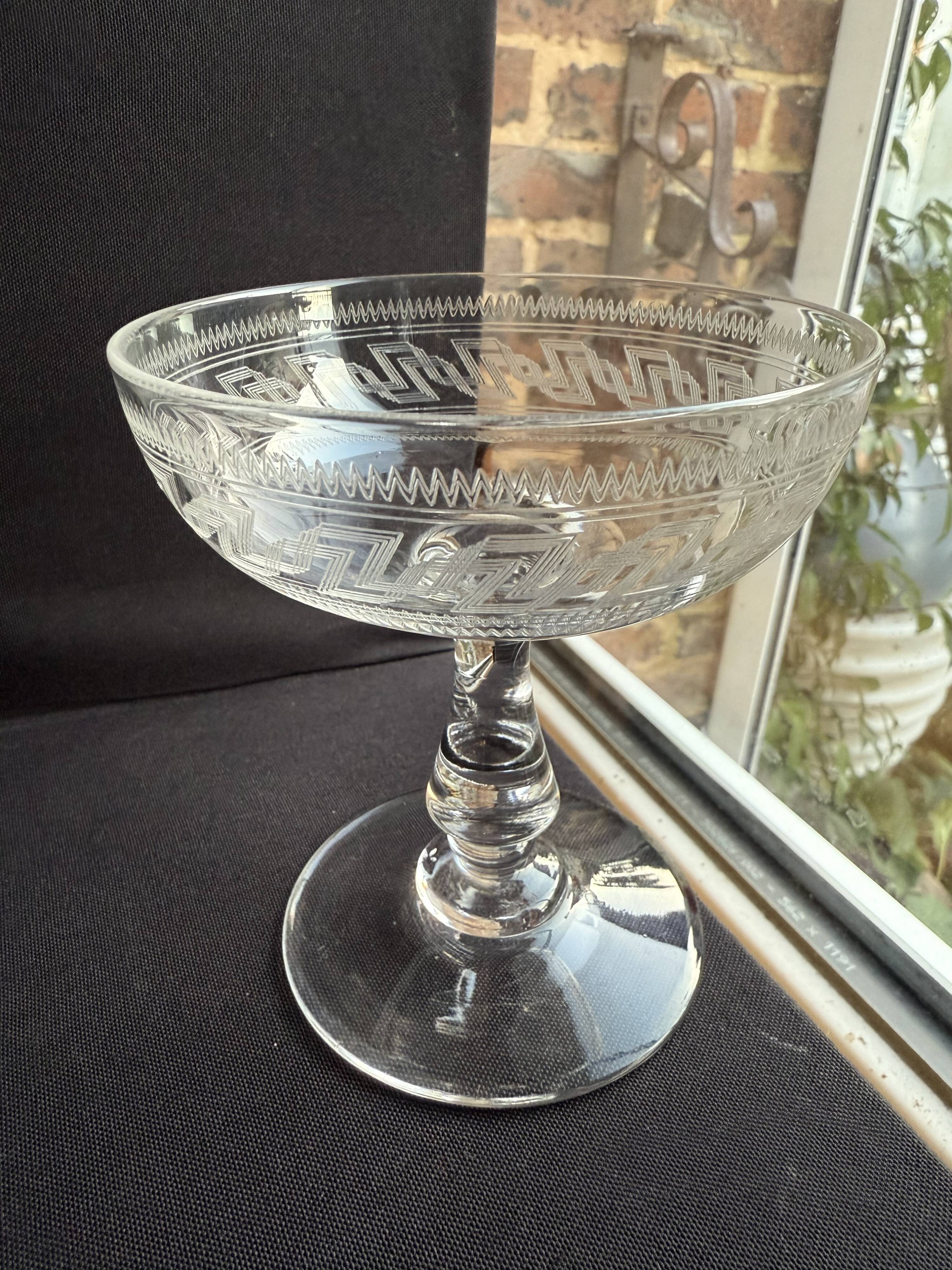 6 Baccarat champagne coupes with Greek engraving, slanted.