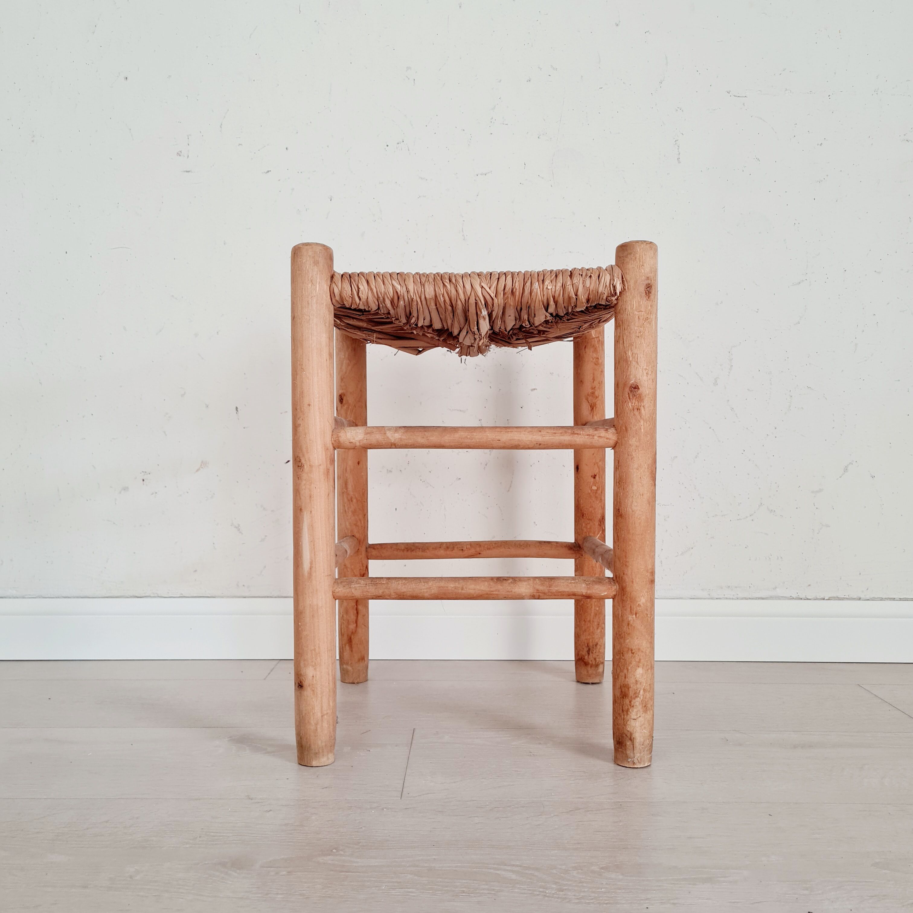 Old stool in wood and straw brutalist look