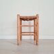 Old stool in wood and straw brutalist look