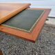 English wood coffee table with leather shelves