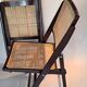 Pair of caned folding chairs from the 1960s in varnished wood.