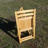 Pair of vintage folding chairs in light wood