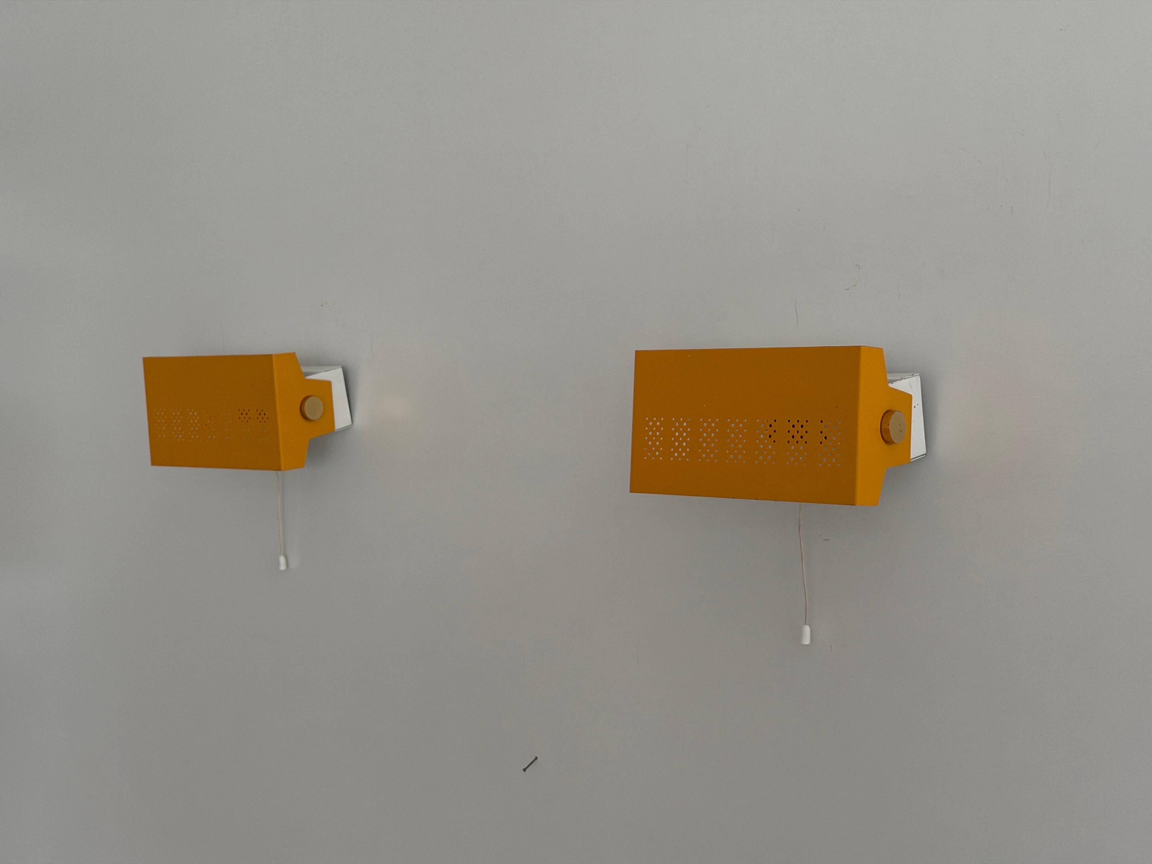 Pair of yellow metal wall lights from the mid-century by N Leuchten, 1960s, Germany.
