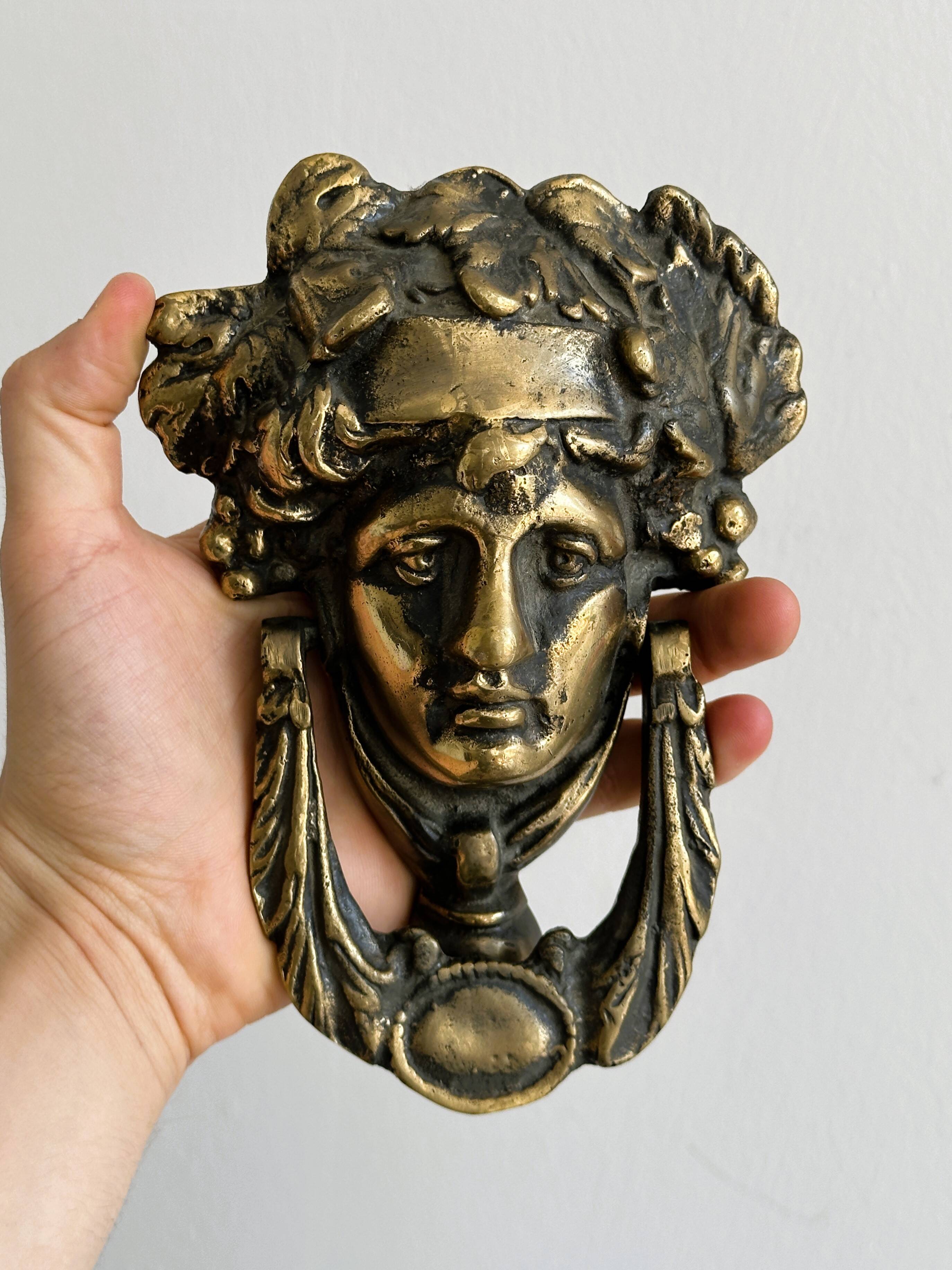 Large antique style brass metal knocker.