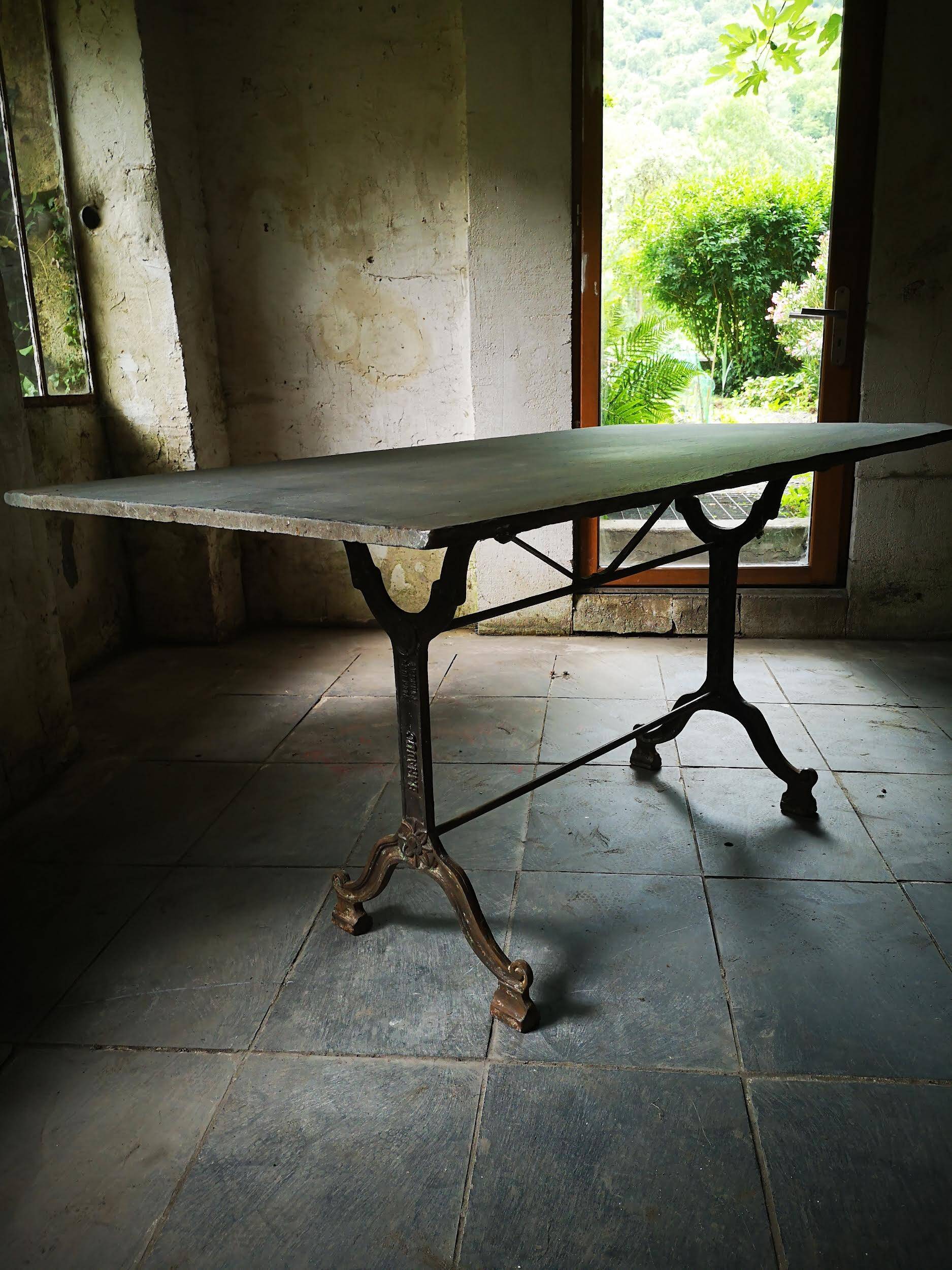 Old bistro table – cast iron legs and natural slate top
